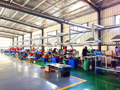 H7617b4a7bf9d4aa4963b128dca0e23a3N an image of factory workers inside dejawuff factory